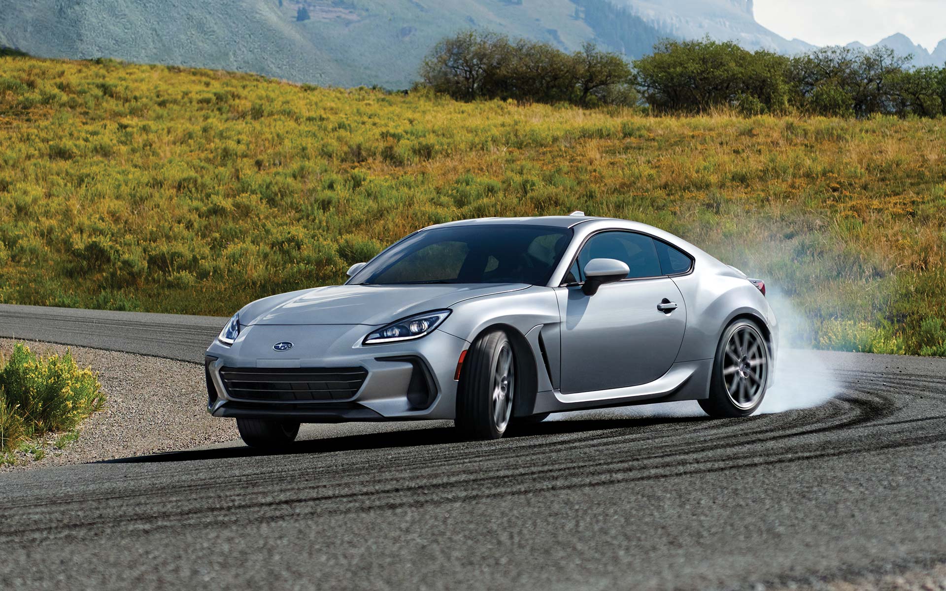 2022 Subaru BRZ Limited shown in Ice Silver Metallic rounding a curve on a highway.