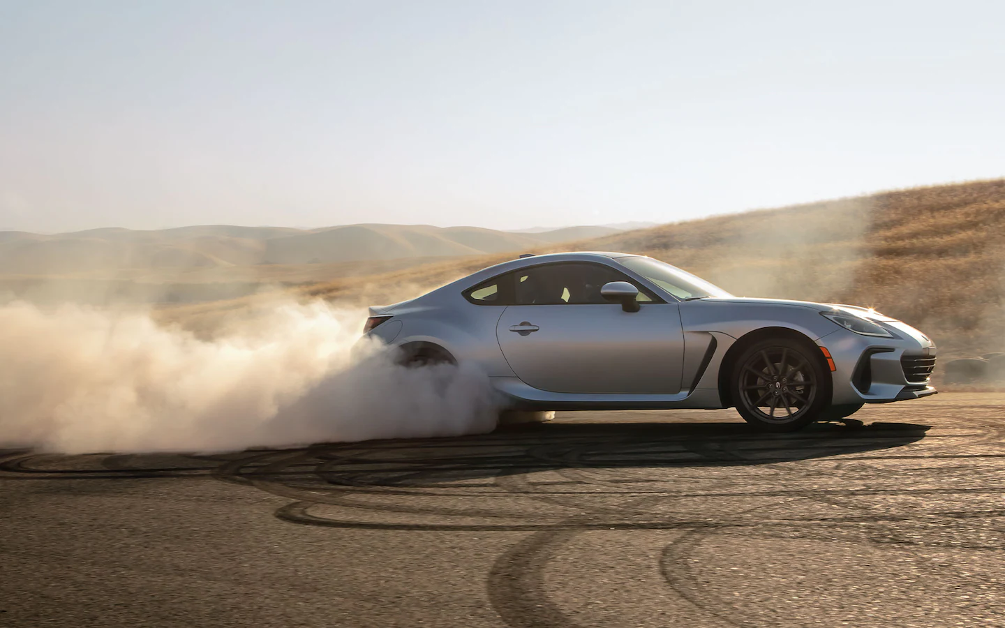 2022 Subaru BRZ Limited shown in Ice Silver Metallic rounding a curve on a highway.